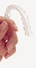 Hand holding Invisalign